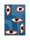 Alfombra rectangular Talismán con diseño de cinco ojos de diferentes tamaños sobre un fondo en dos tonos de azul.