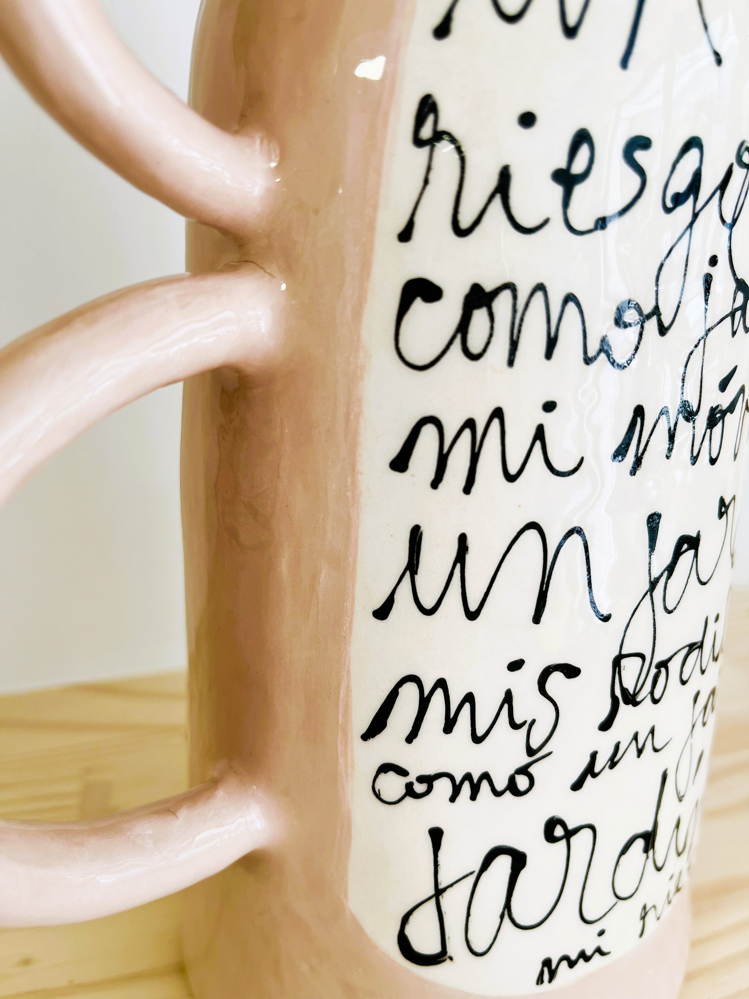 Detalle lateral de las tres asas laterales del Jarrón LETRA cerámico, mostrando la textura artesanal de la cerámica esmaltada.