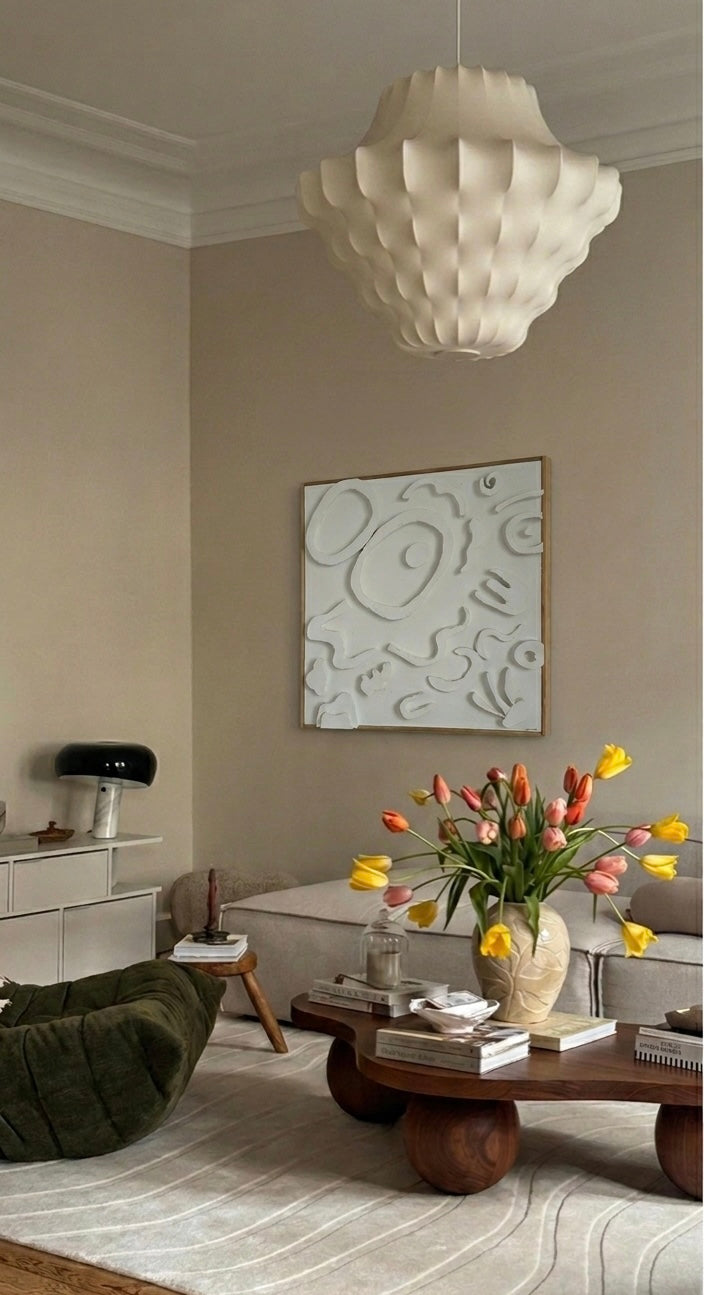 Obra abstracta "FUGA" de Irene Crespo colgada en un salón de tonos neutros, mostrando su gran formato cuadrado y su relieve blanco bajo una luz cálida.